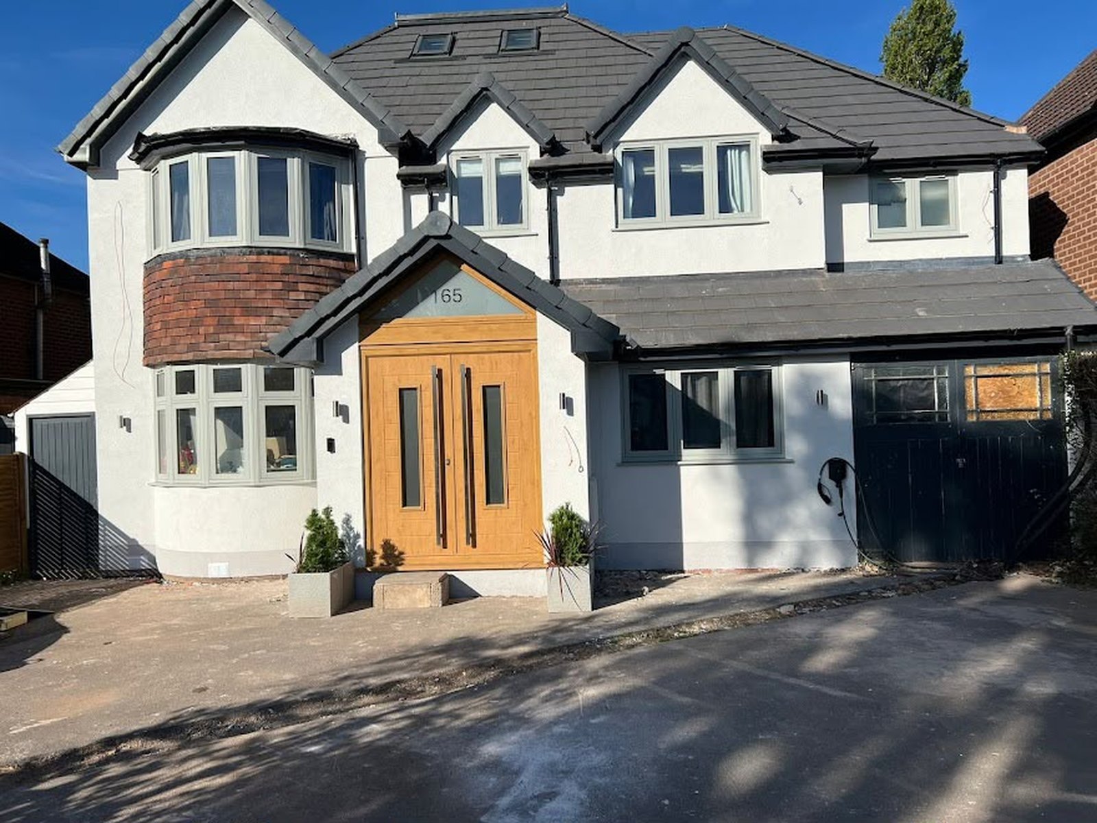 Detached house, Solihull — Complete render refresh with crisp reveals and new rainwater goods.