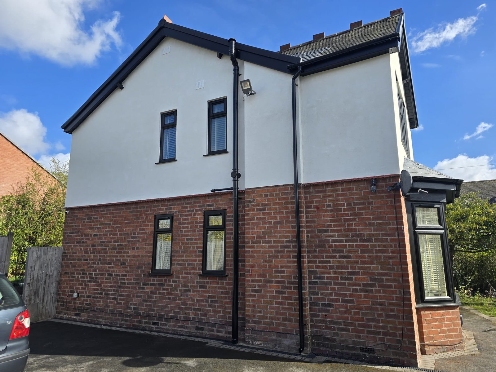Full render, Dudley — Weathered pebble dash replaced with a brilliant white silicone thin-coat render.